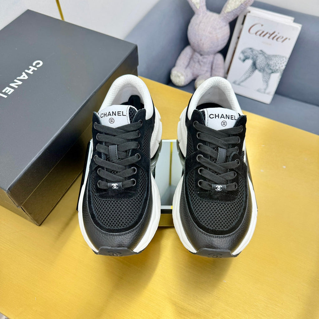 Chanel Sneaker in Black with White Logo Calfskin and Mesh