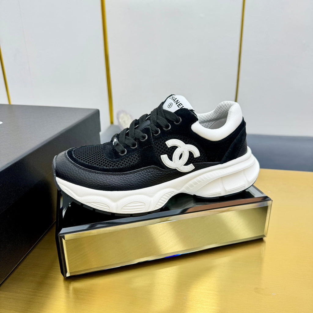 Chanel Sneaker in Black with White Logo Calfskin and Mesh