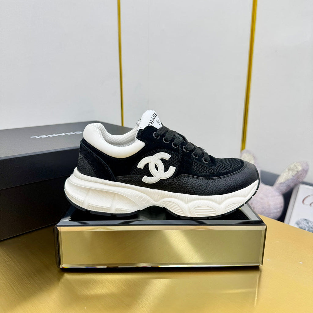 Chanel Sneaker in Black with White Logo Calfskin and Mesh