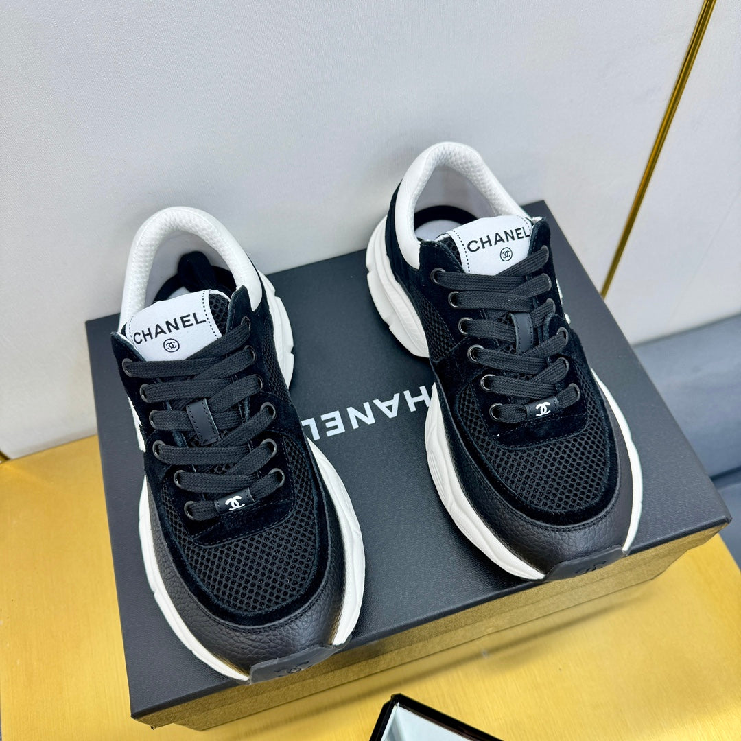 Chanel Sneaker in Black with White Logo Calfskin and Mesh