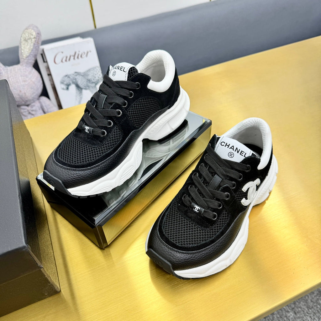 Chanel Sneaker in Black with White Logo Calfskin and Mesh