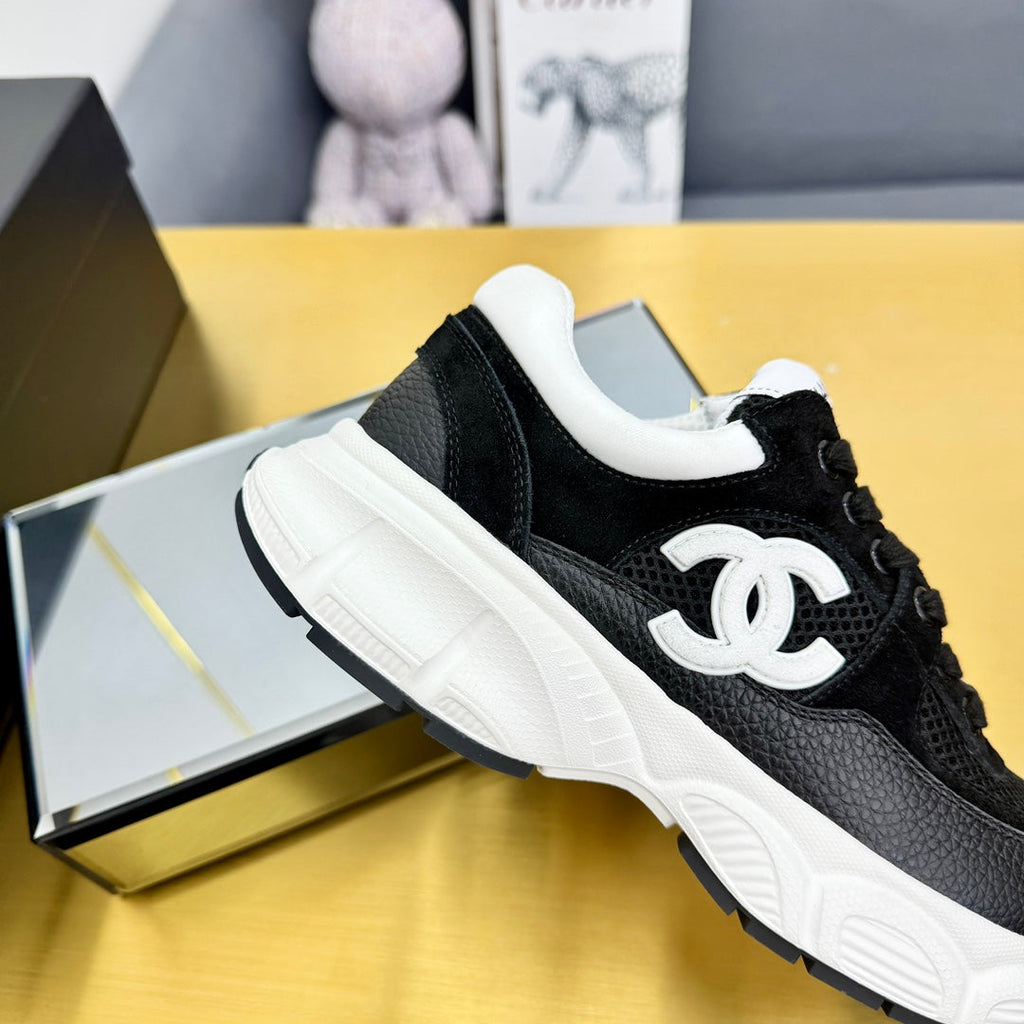 Chanel Sneaker in Black with White Logo Calfskin and Mesh